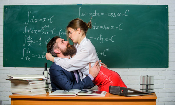 Time for games. Sensual teacher and student play sex games in class. Sexy  couple of sexi woman and bearded man enjoying love games. Erotic role  playing games for adults Stock Photo