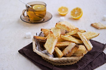Homemade cottage cheese biscuits in a wicker basket on a light background concrete. Baking with cottage cheese.