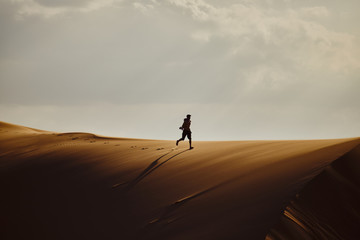 Fototapeta na wymiar People walk on the sands in the Gobi Desert, Mongolia