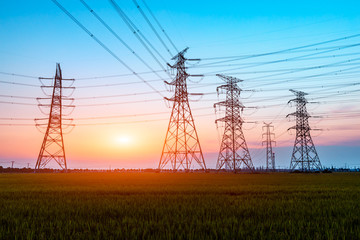 Fototapeta premium Electricity tower silhouette and sky landscape at dusk