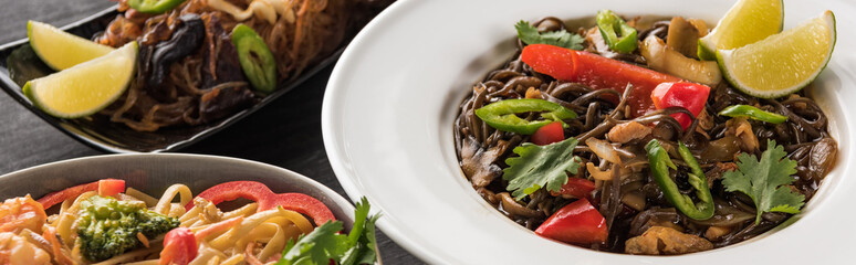 close up view of thai noodles on wooden grey surface, panoramic shot