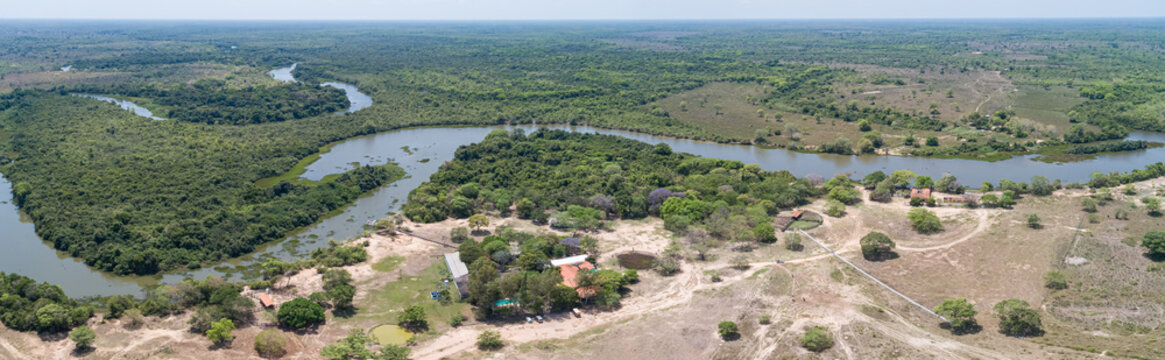 Panoramic areal view of typical Pantanal landscape, meandering tropical river through rainforest and deforested areas, Pantanal Wetlands, Mato Grosso, Brazil