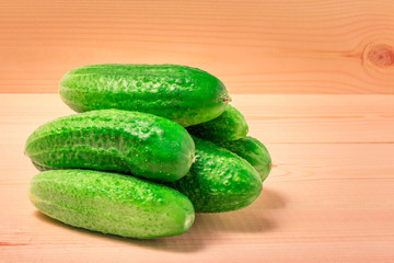 Fresh cucumbers on a wooden background