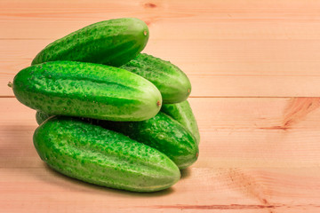 Fresh cucumbers on a wooden background