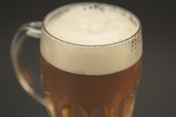 COLD BEER JAR CLOSE UP ON A GREEN COASTER WITH BLACK ELEGANT BACKGROUND