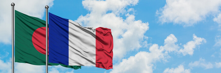 Obraz premium Bangladesh and France flag waving in the wind against white cloudy blue sky together. Diplomacy concept, international relations.