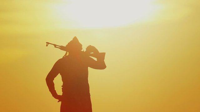 warrior with Kalashnikov at sunset day. fighter is training with a machine gun at sunset.