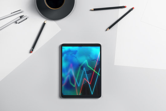 Digital tablet closeup top view with financial graph and partial world map on screen. Online international trading application concept. 3d rendering. - Powered by Adobe