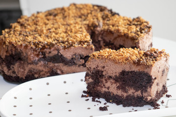  Chocolate Mousse Cake decorated crushed nuts on white plate.