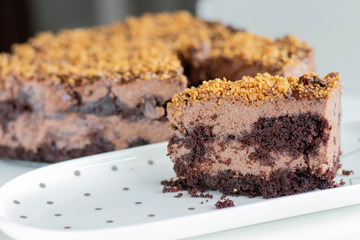 Chocolate nut mousse Cake decorated with crushed nuts. Heart shape.