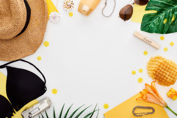 wooden block with june inscription, straw hat, digital camera, lily flower, green leaves, sunglasses, sunscreen, lollipops, waffles, bikini bra isolated on white