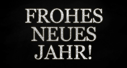 Obraz premium Black background with silver glamour letters with the german word for happy new year - frohes neues jahr