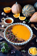 Pumpkin tart on a dark wooden background, still life
