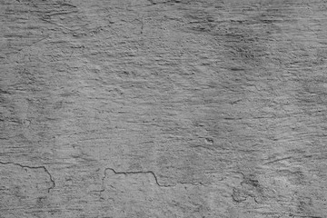 Texture of a concrete wall with cracks and scratches which can be used as a background