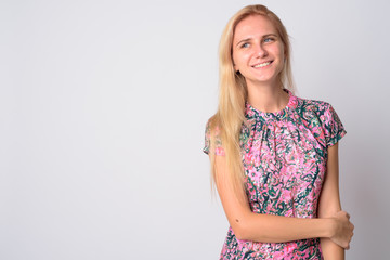 Portrait of happy young beautiful blonde woman thinking