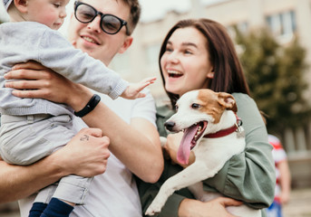 Family bonds. Happy young family of three smiling while spending free time outdoors