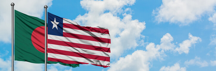 Bangladesh and Liberia flag waving in the wind against white cloudy blue sky together. Diplomacy concept, international relations.