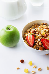 Health food. Muesli with milk, strawberry and the baked apple. High key. Close up. Selective focus.