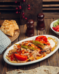 beafsteak is mixed with tomato, fried potatoes and chillis