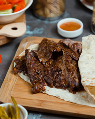 beafsteak is served with lavash on the table