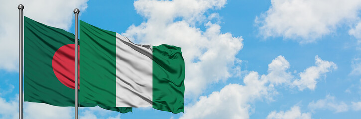 Bangladesh and Nigeria flag waving in the wind against white cloudy blue sky together. Diplomacy concept, international relations.