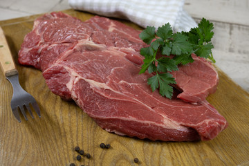 big raw steak on a cutting board