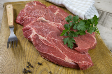big raw steak on a cutting board