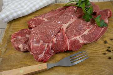 big raw steak on a cutting board