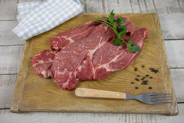 big raw steak on a cutting board