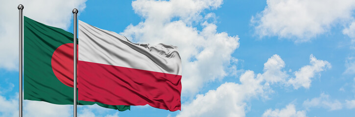 Fototapeta na wymiar Bangladesh and Poland flag waving in the wind against white cloudy blue sky together. Diplomacy concept, international relations.