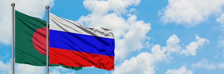 Bangladesh and Russia flag waving in the wind against white cloudy blue sky together. Diplomacy concept, international relations.