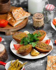 fried minced meat in the bread with piece of tomato and lomen 1