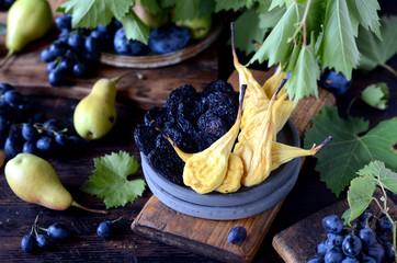 Dried pears and prunes, still life on a dark wooden background