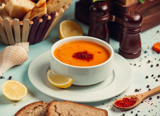 merchi soup is served with slide of lemon in the bowl