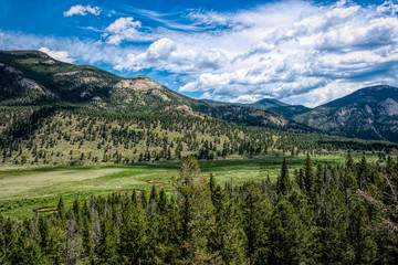 Fototapeta na wymiar Rocky Mountains summer green panorama in Colorado, USA. Mountains and clouds