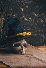 Skull of a sorcerer in a hat on a dark background