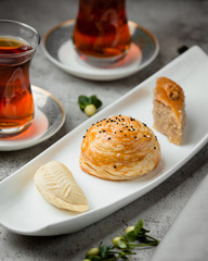 shekerbura, paxlava and qoqal in the dish served two glass of tea