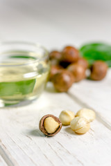 Nice macadamia nuts on the white wooden table.