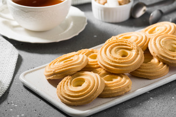 Cookies on a white ceramic tray on the gray kitchen table