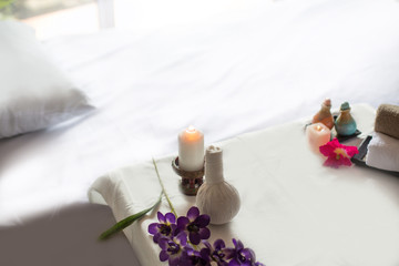 Obraz na płótnie Canvas Spa treatments on White spa massage bed with candles, massage oil