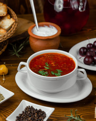 tomato soup is in the bowl served with mayonnaise