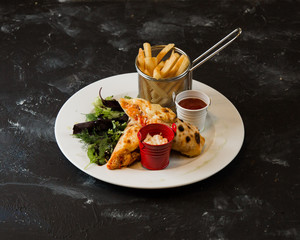 vegetable crepes served with fried potato, greens and ketchup