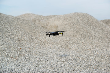 Fototapeta na wymiar Drone on Granite gravel texture outdoor.