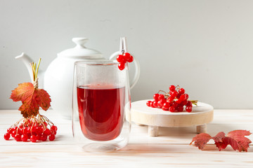 Vitamin tea from viburnum berries in a glass transparent mug on a white background