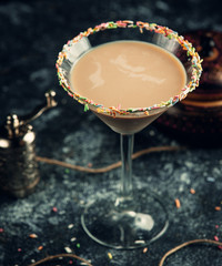 glass of cappuccino with decorated small candy