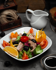 mixed vegetable salat with boiled meat in the plate