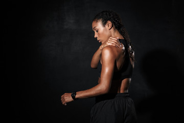 Image from back of feminine african american woman in sportswear