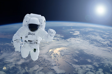 Astronaut above the planet Earth. Elements of this image were furnished by NASA.