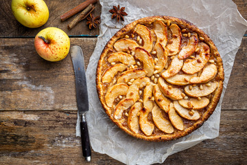 Homemade delicious fresh baked rustic apple pie on dark background, top view