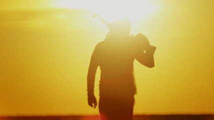 warrior with Kalashnikov at sunset day. fighter is training with a machine gun at sunset.